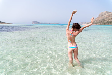 a happy girl enjoying blue sea
