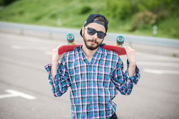 Stylish young guy on a red skateboard © ces