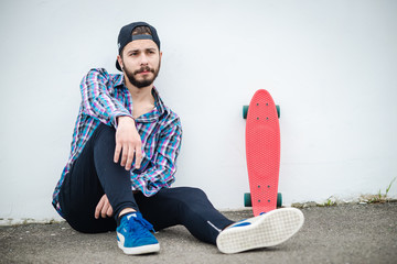 Stylish young guy on a red skateboard © ces