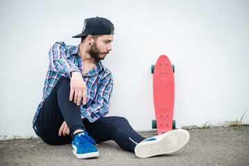 Stylish young guy on a red skateboard © ces