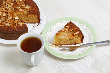 Piece of pie with pears, peanuts and cookies-sticks