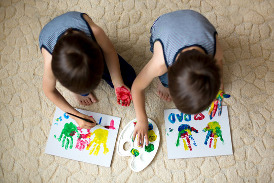 Two adorable boys, preparing fathers day gift for dad,  painting