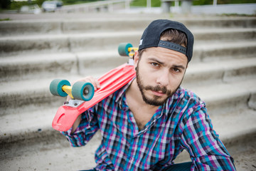 Stylish young guy on a red skateboard © ces