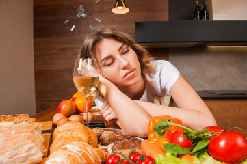 Pretty Housewife sleeping on the table with glass of wine