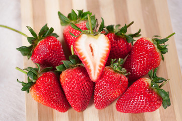 Stack strawberries on wood floor