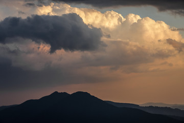 Clouds over mountains at sunset