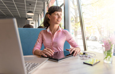 girl studying in the cafe with a tablet