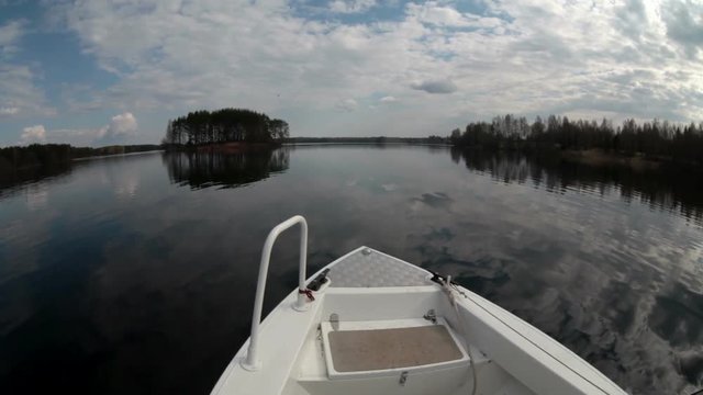 Calm water surface of lake with riding speedboat, wide angle view