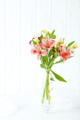 Beautiful alstroemeria flowers on a white wooden table