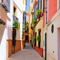 Colorful street in the beautiful old town of Sevilla, Spain - obrazy, fototapety, plakaty