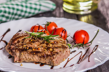 steak and tomatoes on a plate
