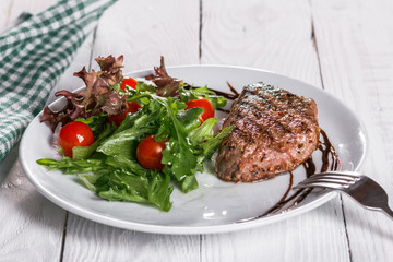 steak and salad on a plate