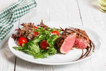 steak and salad on a plate