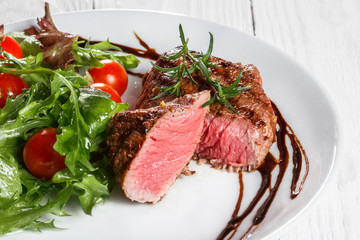 steak and salad on a plate