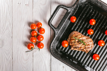 steak and cherry tomatoes in a pan