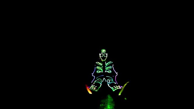 4 people dancing in costumes of LEDs