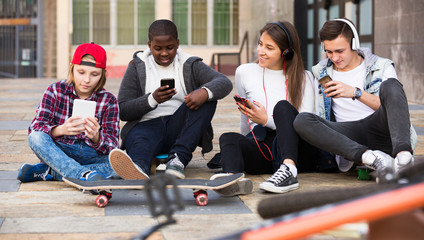 Teenage relaxing with mobile phones