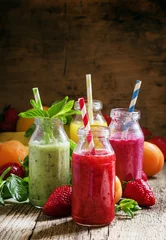 Keuken spatwand met foto Multi-colored bottles with fresh fruit smoothies with striped st © 5ph