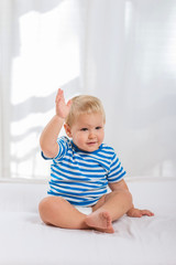 Fototapeta premium Happy baby smiling and waving hand