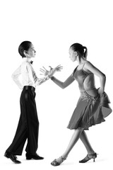 Boy and girl or beautiful couple in the active ballroom dance on white background