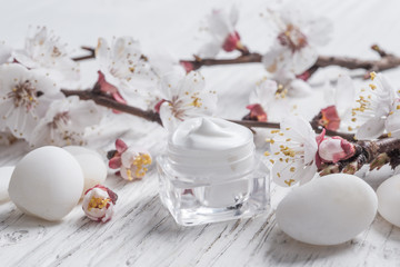Fototapeta na wymiar Facial cream with beauty cherry blossoms 