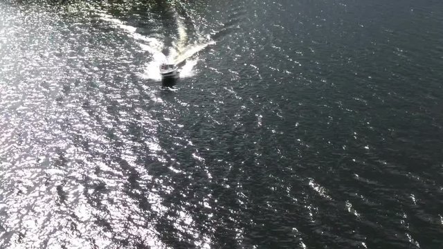 Powerboat racing on the water, slow motion, aerial view
