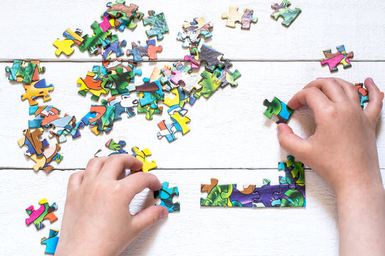 Child collects a picture from puzzles