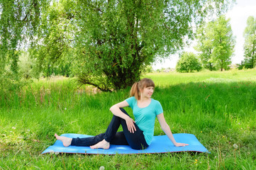 Smiling girl practices yoga
