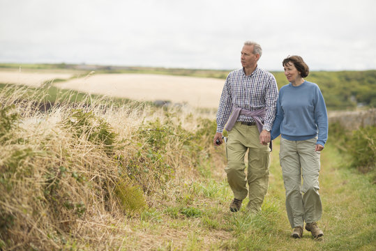 Couple walking, Coast Path near Marloes, Pembrokeshire Coast National Park, Wales, UK