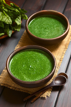 Frische Spinatcremesuppe oder Spinatrahmsuppe in rustikale Sch&uuml;sseln, fotografiert mit nat&uuml;rlichem Licht (Selektiver Fokus, Fokus in die Mitte der ersten Suppe)