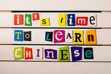 It's time to learn chinese - written with color magazine letter clippings on wooden board. Chinese language learning