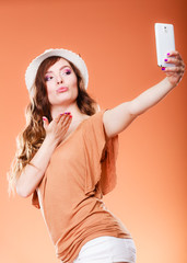 Woman taking self picture with smartphone camera
