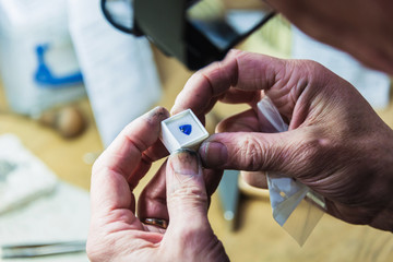 Close up of jewellery craftsman examining gemstone