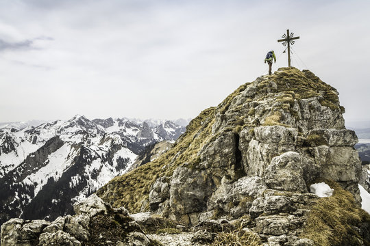 Young male hiker on peak of Klammspitze mountain, Oberammergau, Bavaria, Germany