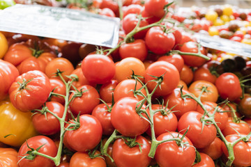 Red tomatoes with price signs in a market in Paris, France