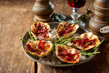 Plate of Kilpatrick Oysters on Wood Table