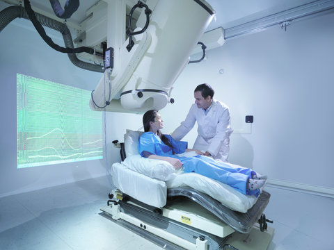 Doctor with patient using magnetoencephalography (MEG) scanner
