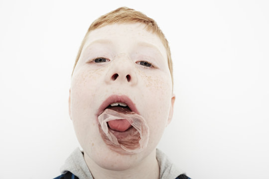 Boy's bubble gum exploding on his mouth