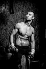 Fototapeta na wymiar Young muscular man in gym
