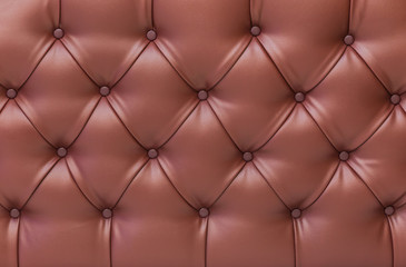 Close up brown vintage sofa leather buttoned armchair texture.