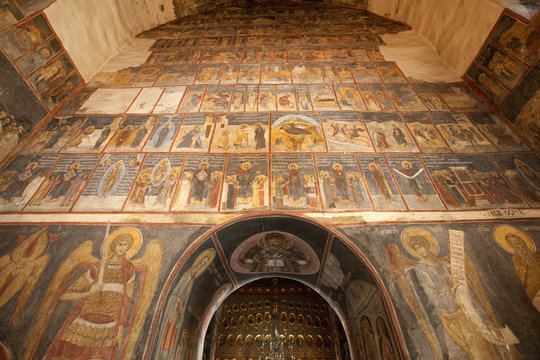 Arched doorway in orthodox church with romanesque frescoes, Bucharest, Romania