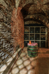 Wine bottles stacked in the old wine cellar