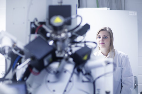 Female scientist using scanning electron microscope in lab