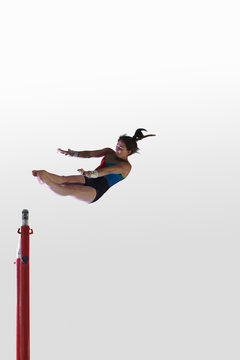 Young gymnast performing on uneven bars