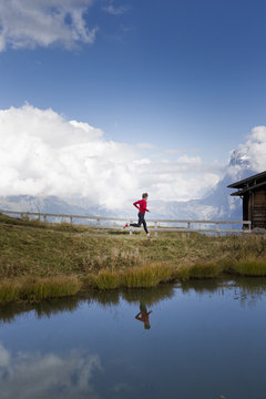 Man running along lakeside, Kleine Scheidegg, Grindelwald, Switzerland