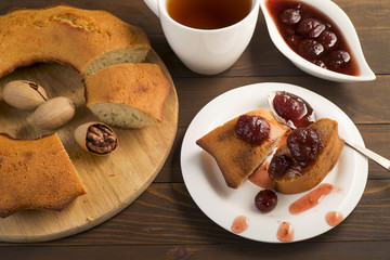 Sweet lush cupcake with strawberry jam and tea