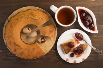 Sweet lush cupcake with strawberry jam and tea