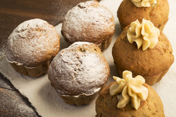 Sweet, lush cupcakes with cream and dusted with powdered sugar