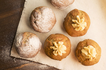 Sweet, lush cupcakes with cream and dusted with powdered sugar