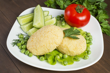 Potato patties with tomato, cucumber, green peas